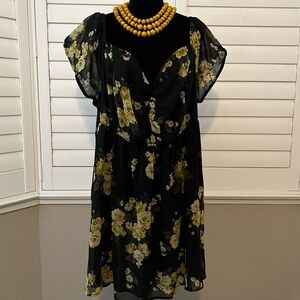 Black and yellow floral tunic with a V-neck and short sleeves.